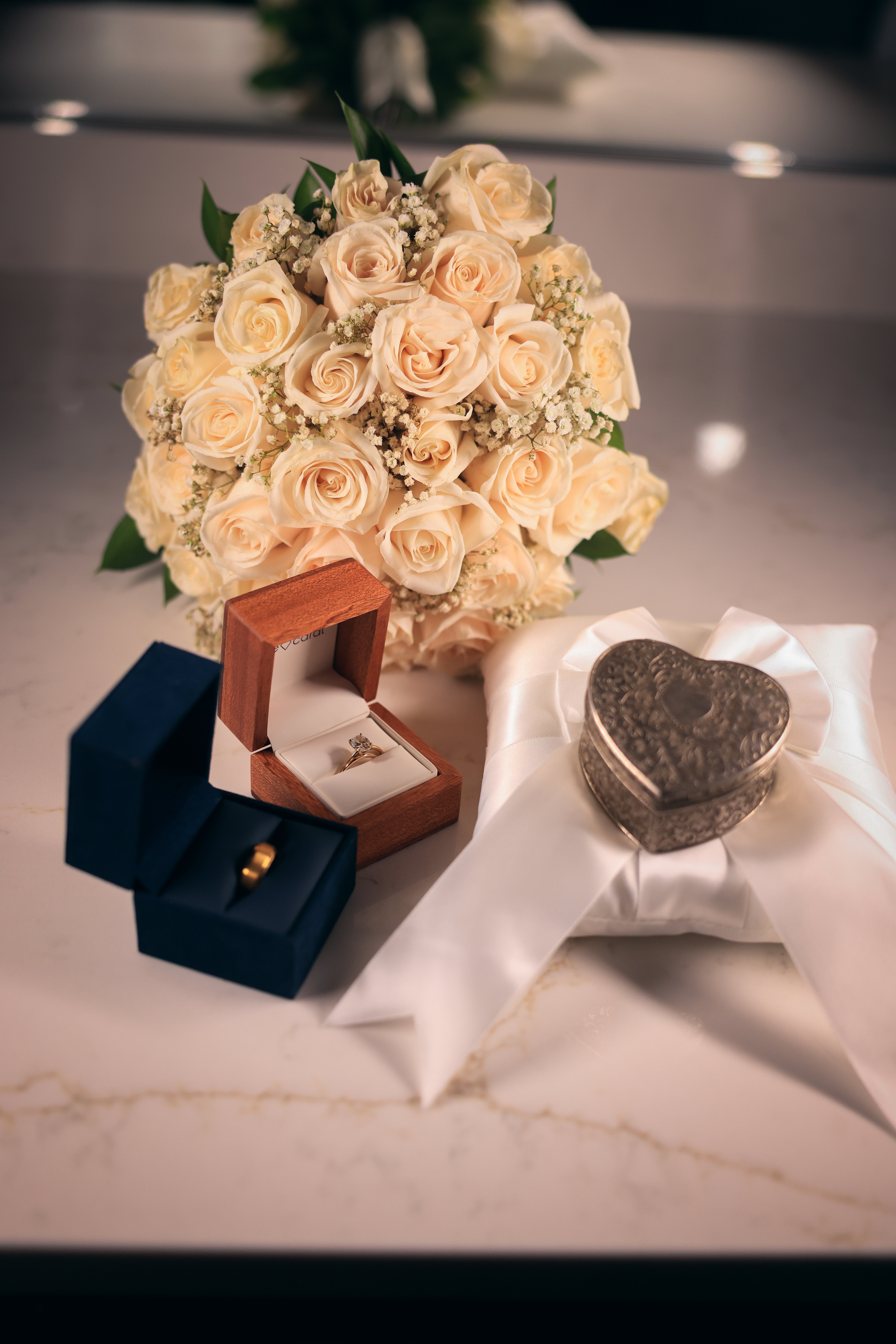 Wedding rings and bridal bouquet detail